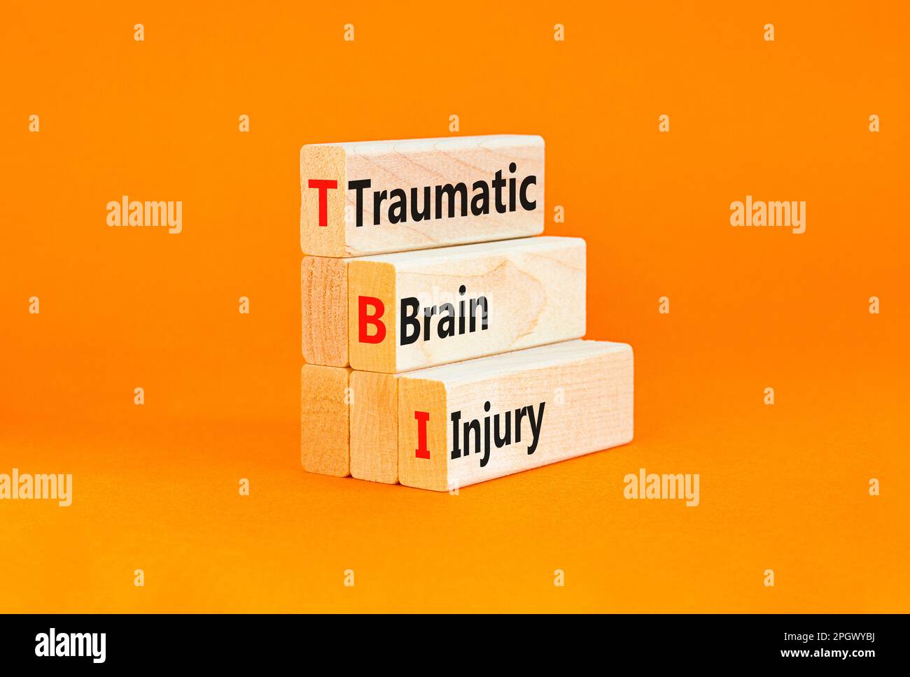 TBI traumatic brain injury symbol. Concept words TBI traumatic brain injury on wooden blocks on a beautiful orange table orange background. Medical an Stock Photo