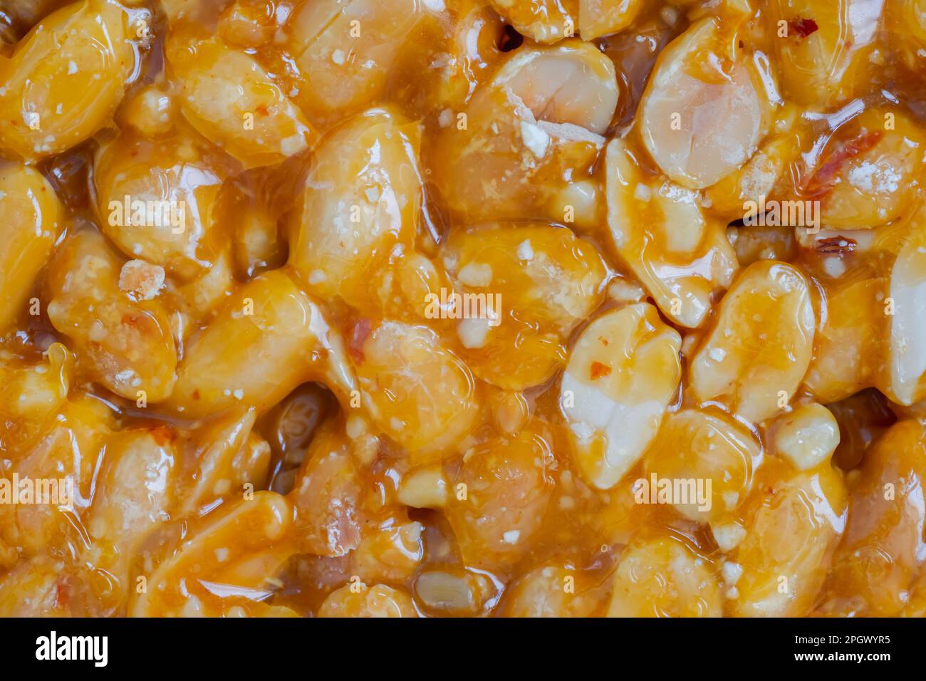 Caramelized nuts fried in honey granola peanut bar close up, top