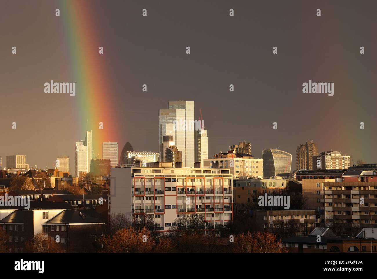 London, UK 24th March 2023. View of dramatic rainbow over the City skyscrapers, in London's unsettled weather with heavy showers and sunshine. Credit : Monica Wells/Alamy Live News Stock Photo