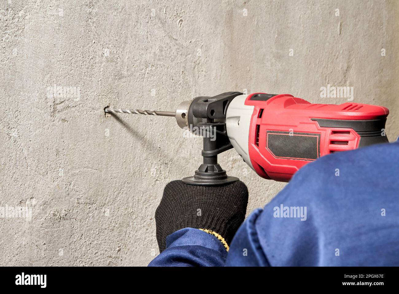 Drilling a hole in the wall with a drill Stock Photo Alamy