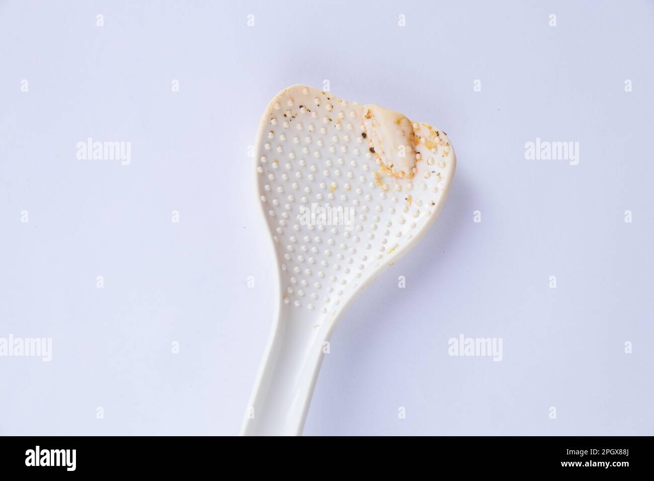 worn plastic spoon for multicooker Stock Photo