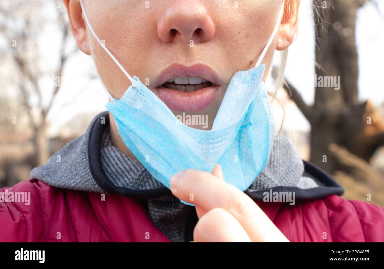 closeup of a young Ukrainian woman in a medical mask on her face during Stock Photo