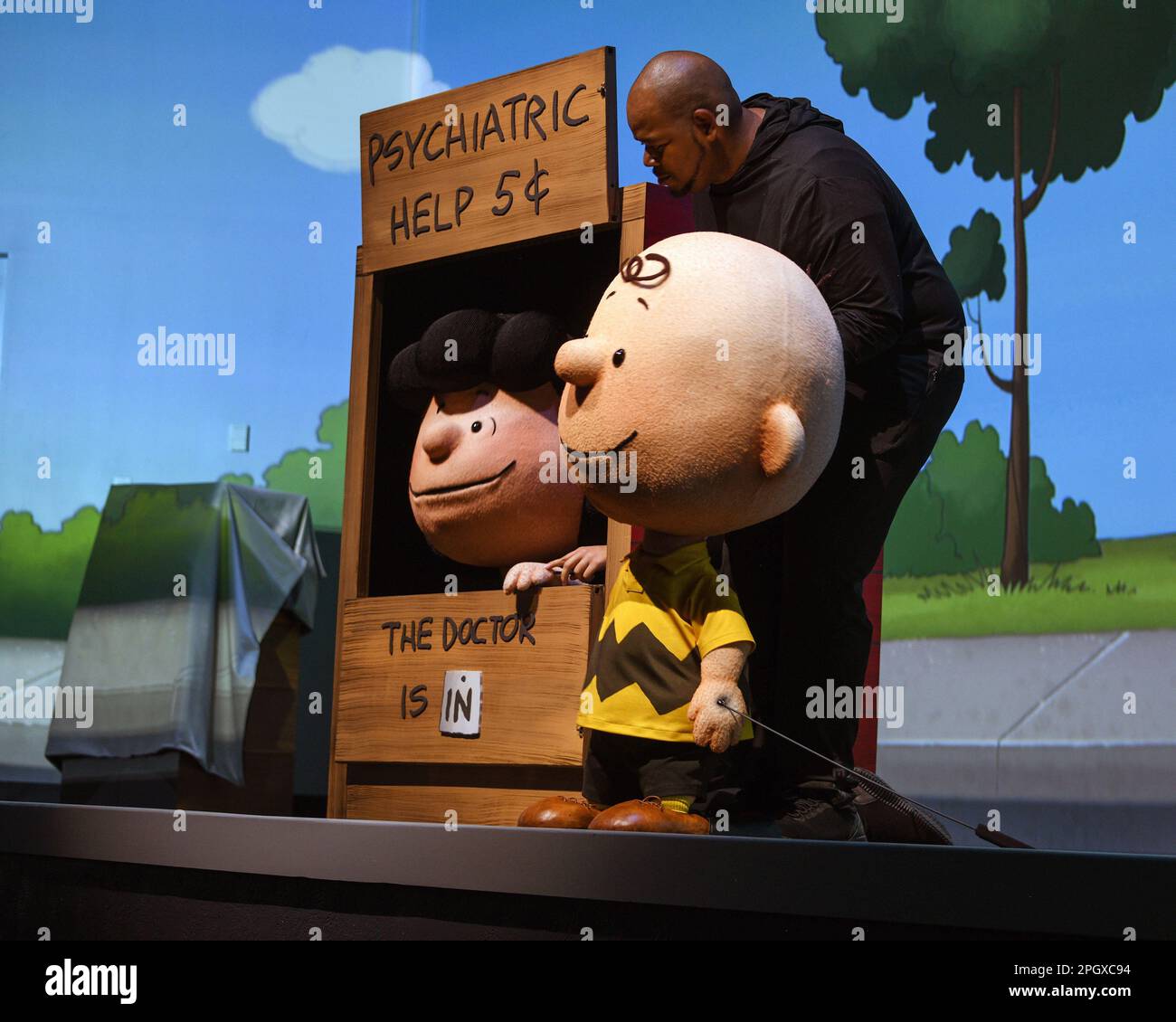 Peanuts characters lucy, Charlie Brown and their puppeteers perform