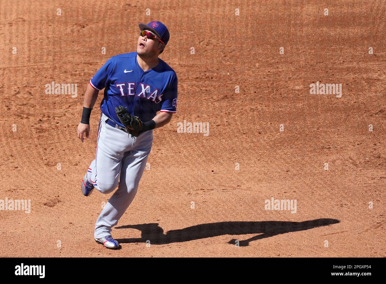 Texas Rangers first baseman Yoshi Tsutsugo, of Japan, runs after a foul  ball during the fifth inning of a spring training baseball game against the  Chicago Cubs Friday, March 24, 2023, in