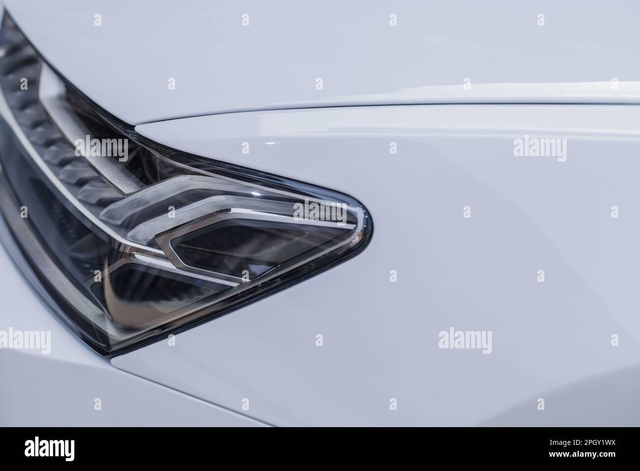 Close up of the headlight of a white Audi Aicon concept car, self-driving luxury sedan with electric propulsion scheme. Stock Photo