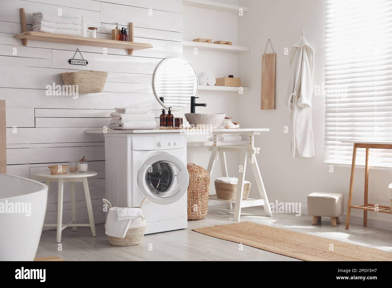 Stylish bathroom interior with modern washing machine Stock Photo