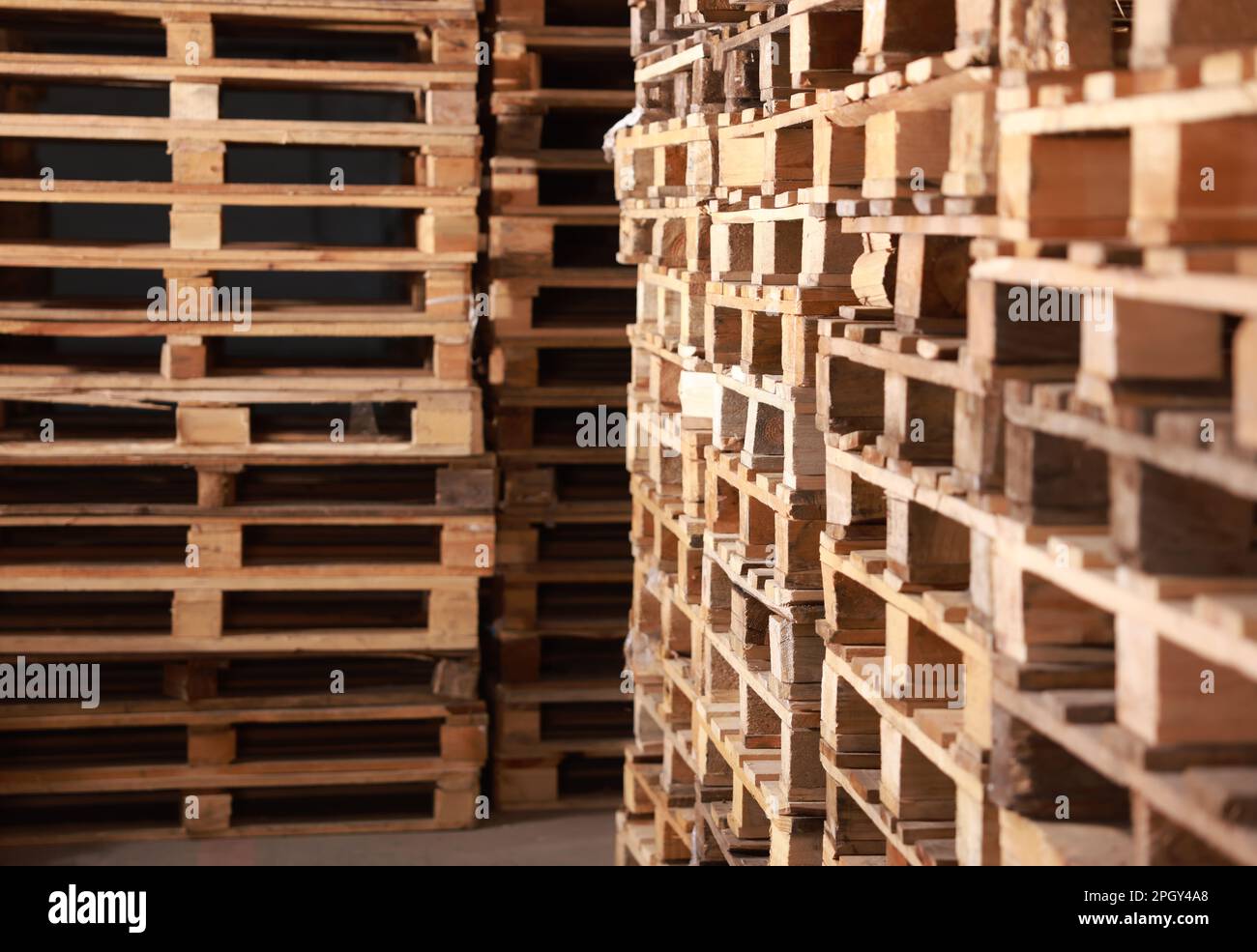 Many empty wooden pallets stacked in warehouse Stock Photo Alamy