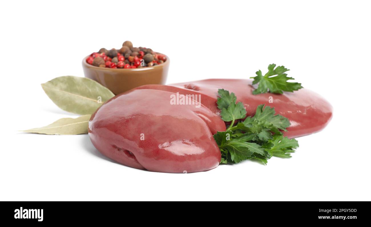 Fresh raw pork kidney with parsley, bay leaves and peppercorns on white