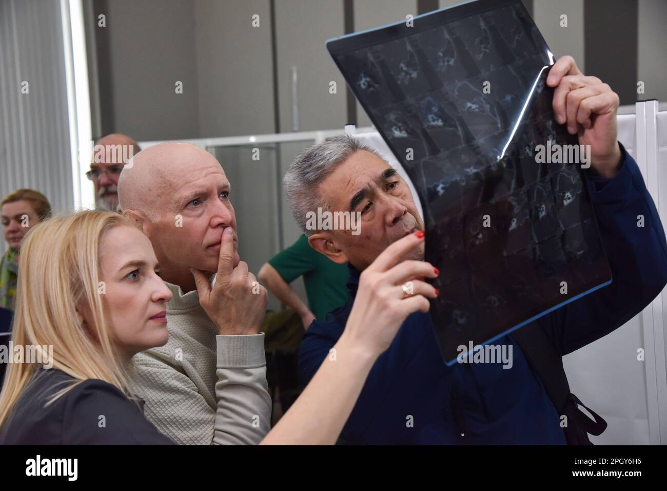Lviv, Ukraine. 20th Mar, 2023. American surgeons examine an Xray of a