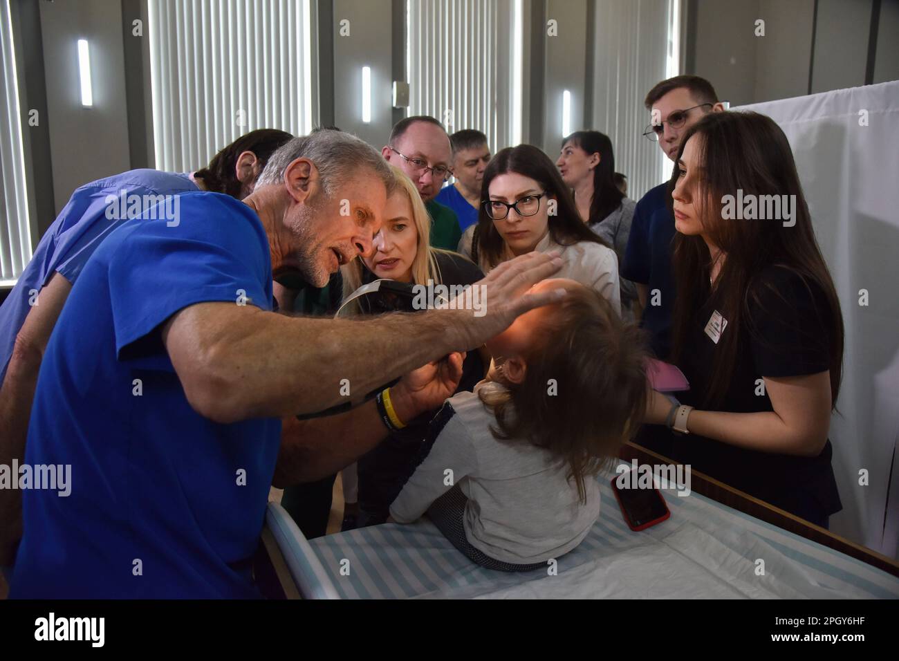 Lviv, Ukraine. 20th Mar, 2023. American surgeons examine a Ukrainian