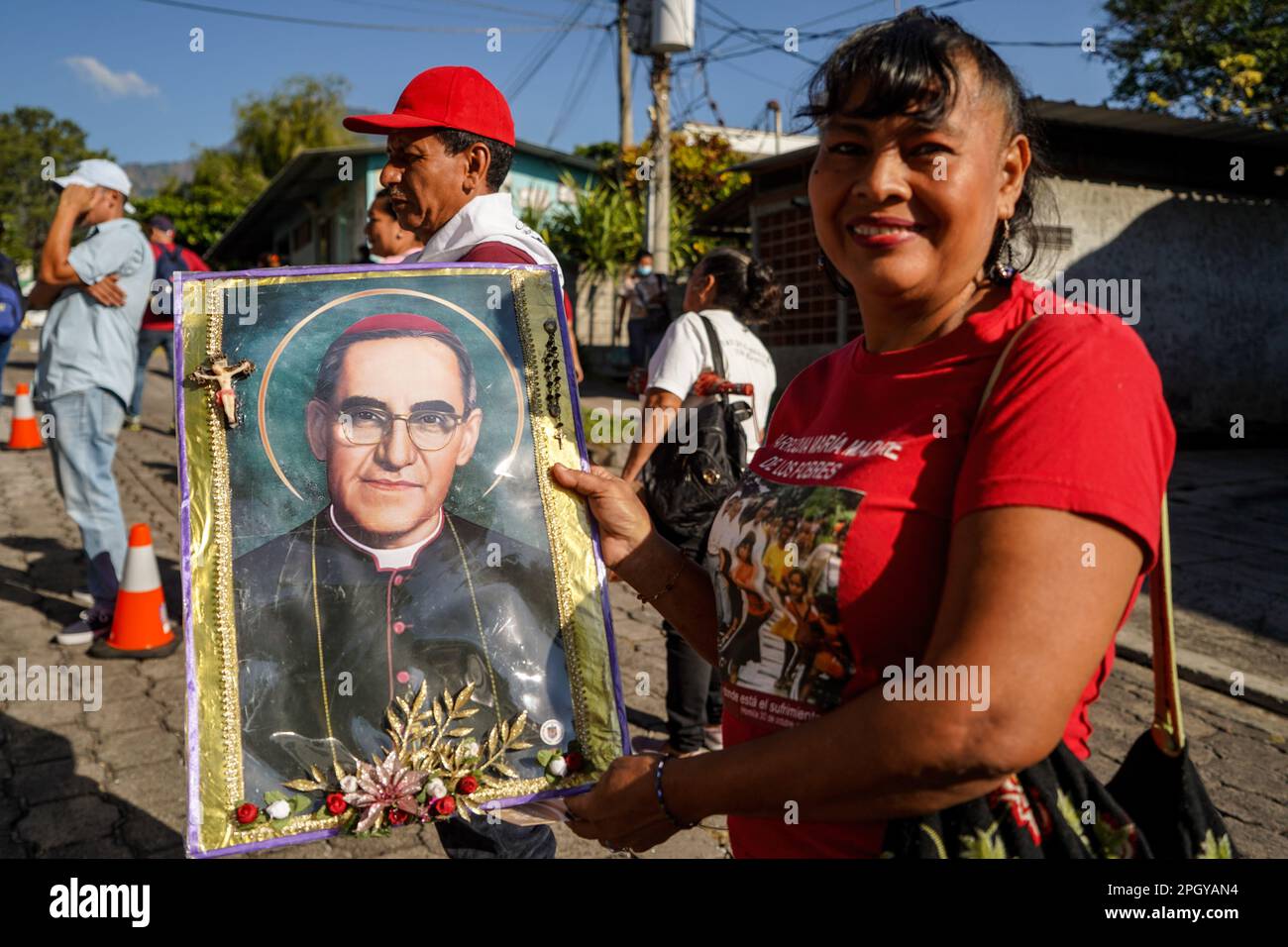 San Salvador, El Salvador. 24th Mar, 2023. A reveler holds a poster depicting Saint Oscar Arnulfo Romero during a procession to the San Salvador cathedral. On March 24th 1980 Archbishop Oscar Romero was assassinated by death squads while giving mass at the Divina Providencia chapel. Credit: SOPA Images Limited/Alamy Live News Stock Photo
