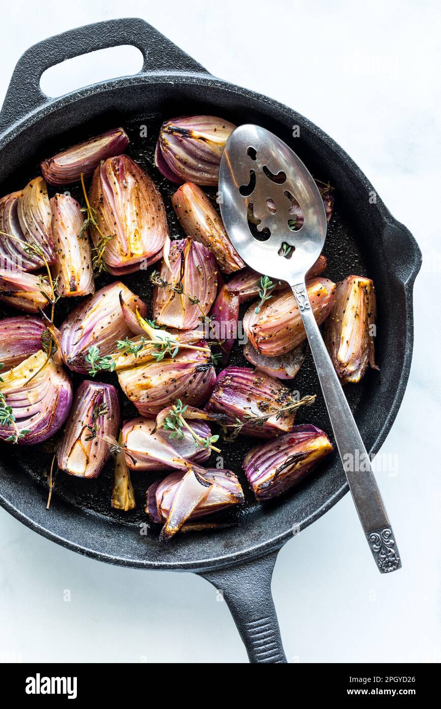 Roasted and caramelized red onions in a cast iron skillet, ready for