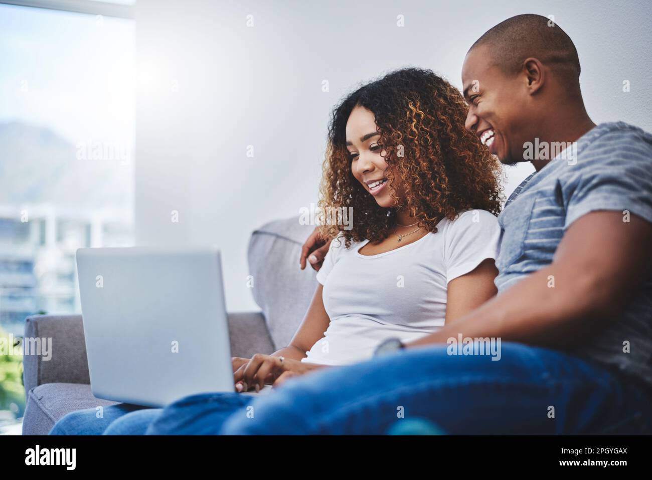Woman sitting across couch hi-res stock photography and images - Alamy