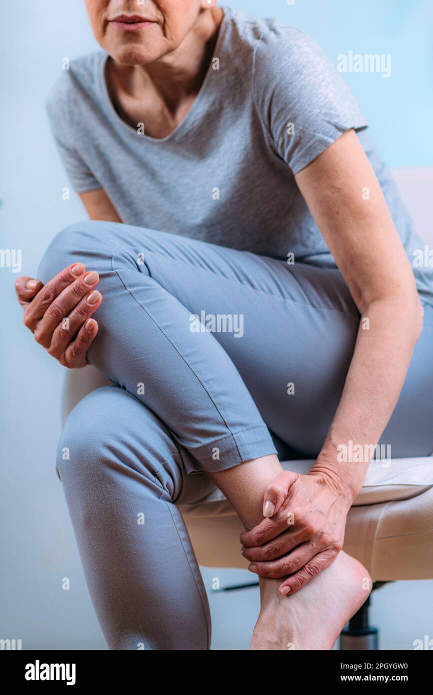 Senior woman with ankle pain Stock Photo