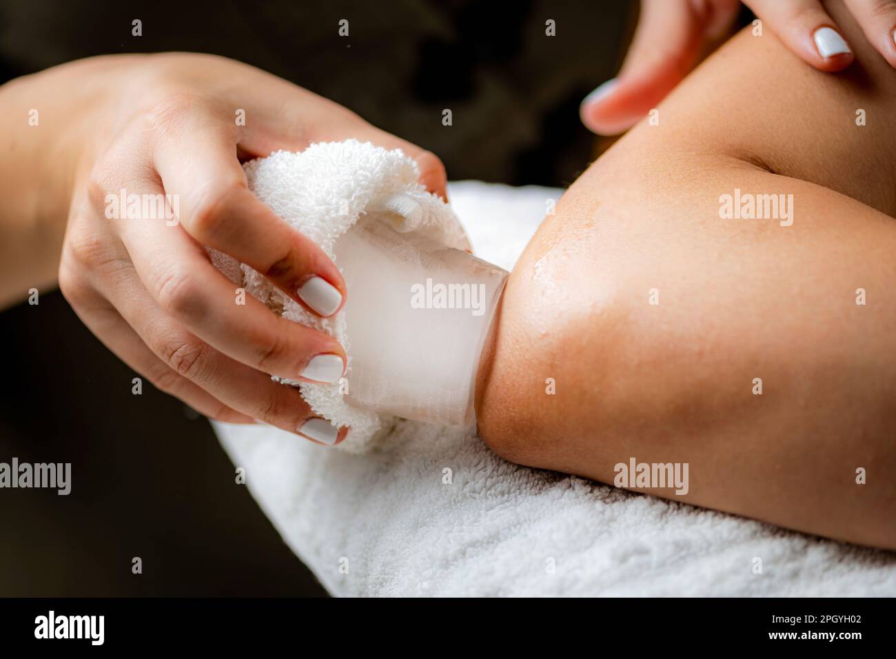Ice massage for painful elbow Stock Photo