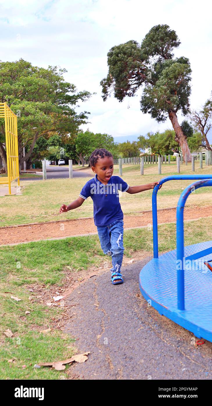 black African boy child playing in a park joyful Stock Photo - Alamy