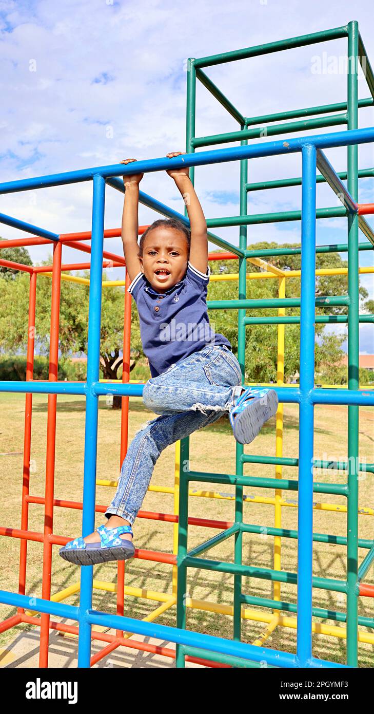 Child playing on monkey bars hi-res stock photography and images - Alamy