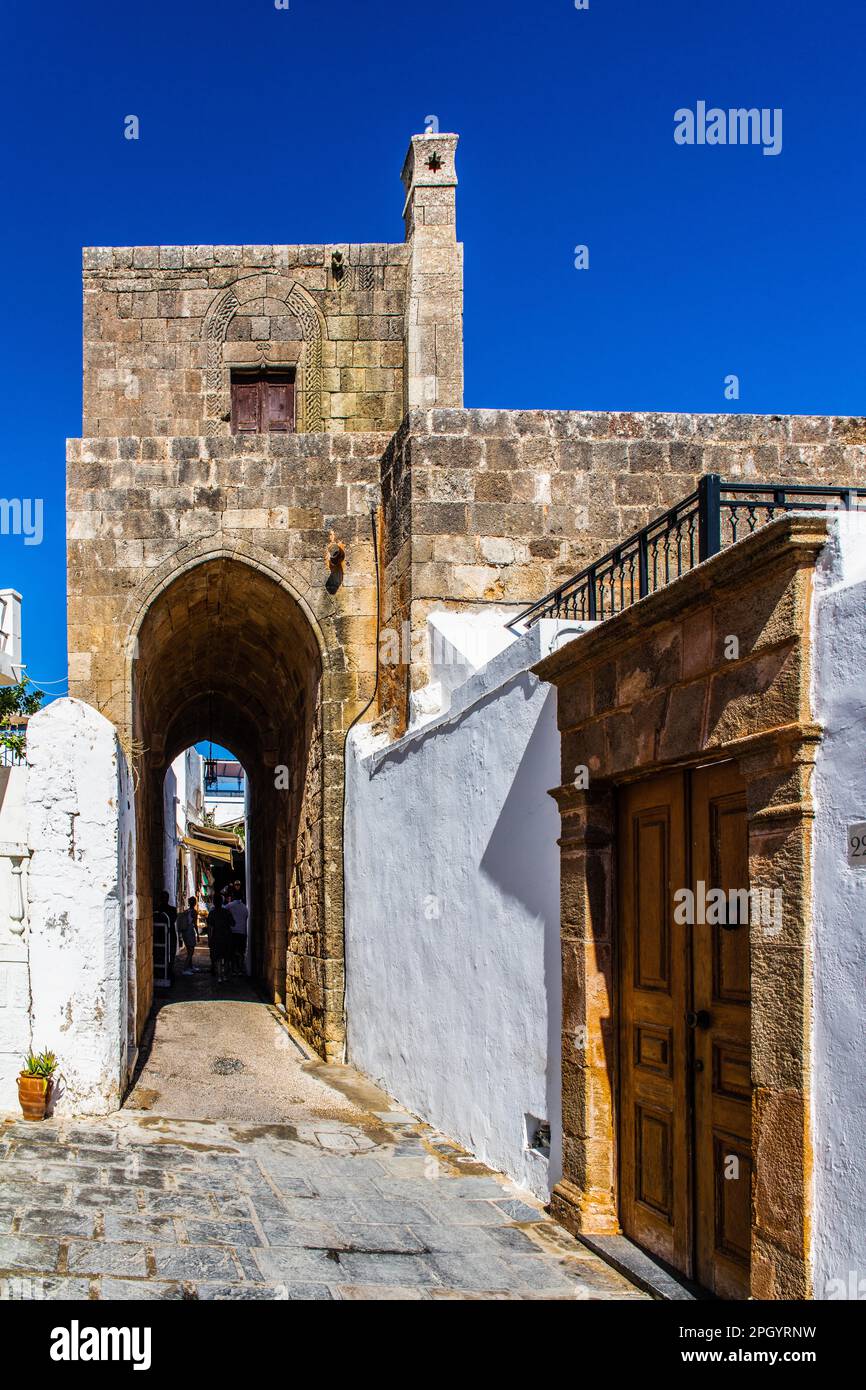 Captains house in the winding streets with white houses, Lindos, Rhodes, Greece Stock Photo