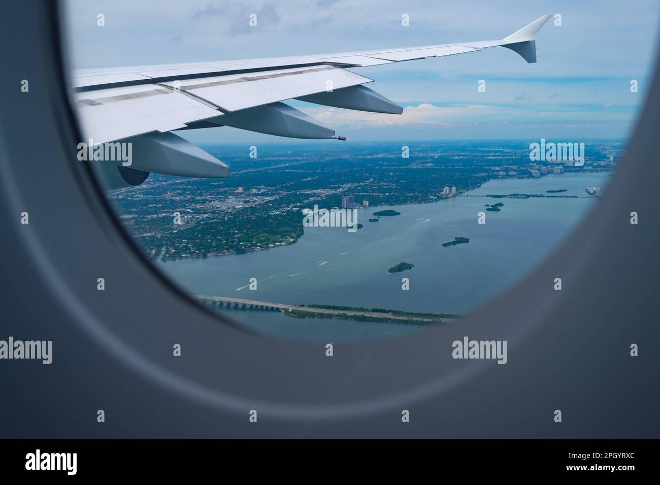 View from porthole. Aircraft window or porthole. Aircraft wing seen