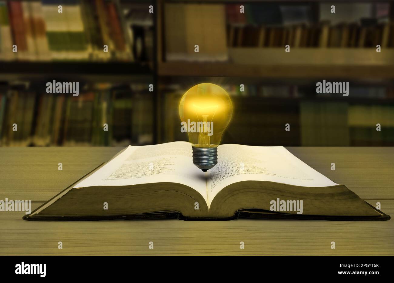 Library Bulb light bulb on the book library background education Stock Photo - Alamy