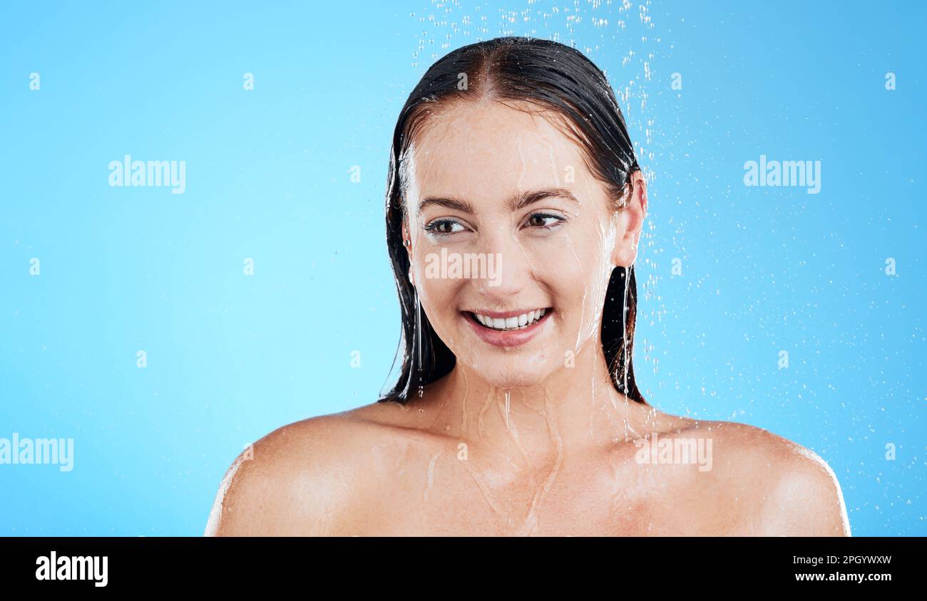Water, shower and happy woman washing in studio for skincare, wellness and clean body for self