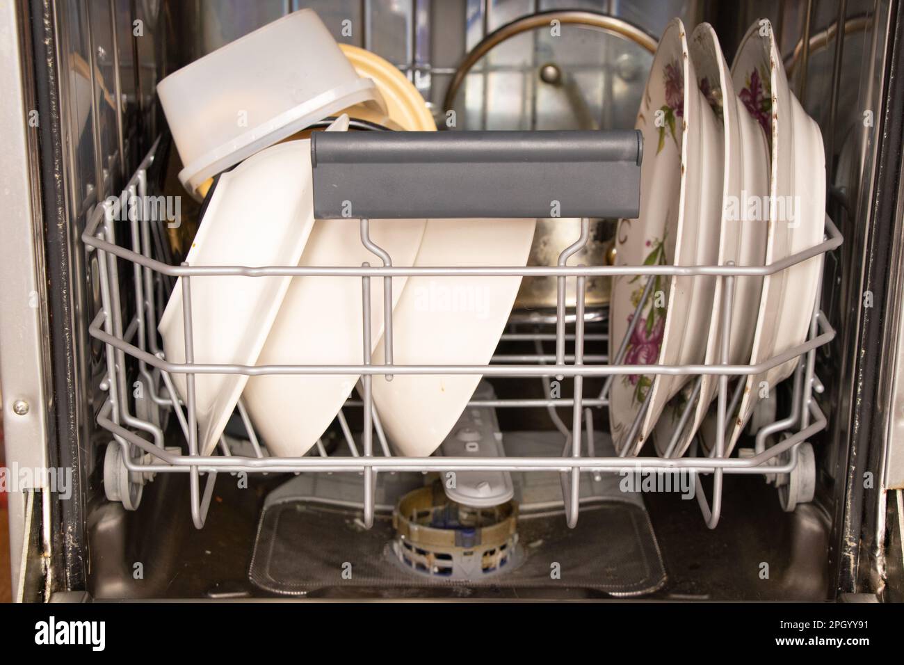 dirty dishes are in the dishwasher container, washing dishes Stock