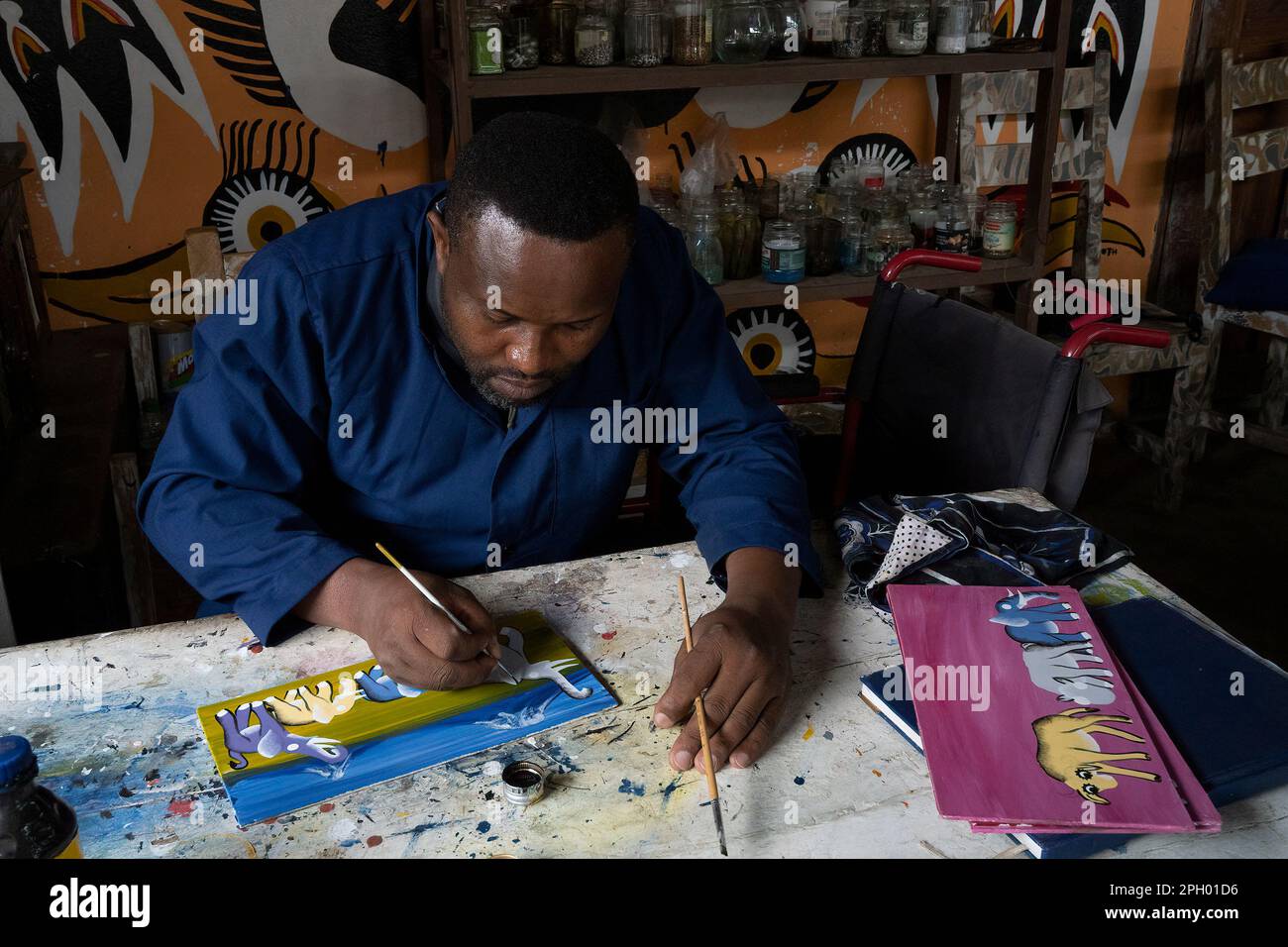 Arusha, Tanzania - October 17th, 2022: A participant in the Shanga project for disabled people, creating door signs. Stock Photo