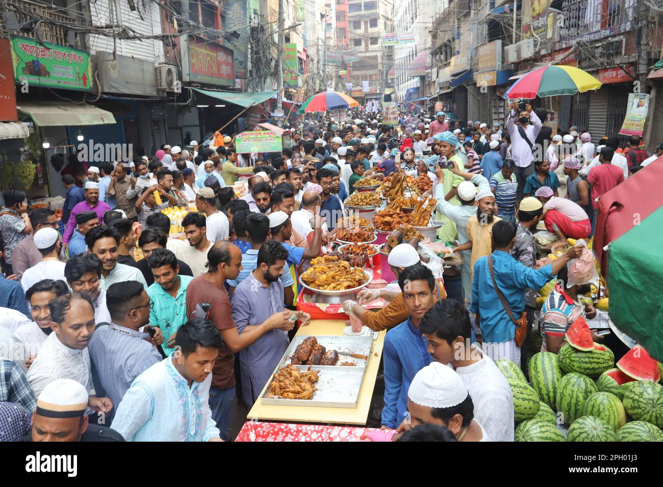 Muslims thronged the street outside Shahi Mosque in Old Dhaka’s Chawkbazar for traditional Iftar items to break the fast on the first day of Ramadan o Stock Photo