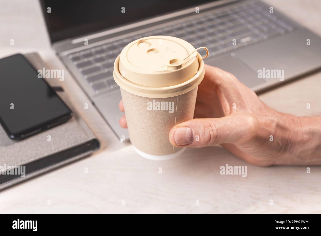hand-holding-beige-paper-cup-takeaway-takeout-coffee-mug-with-lid-at