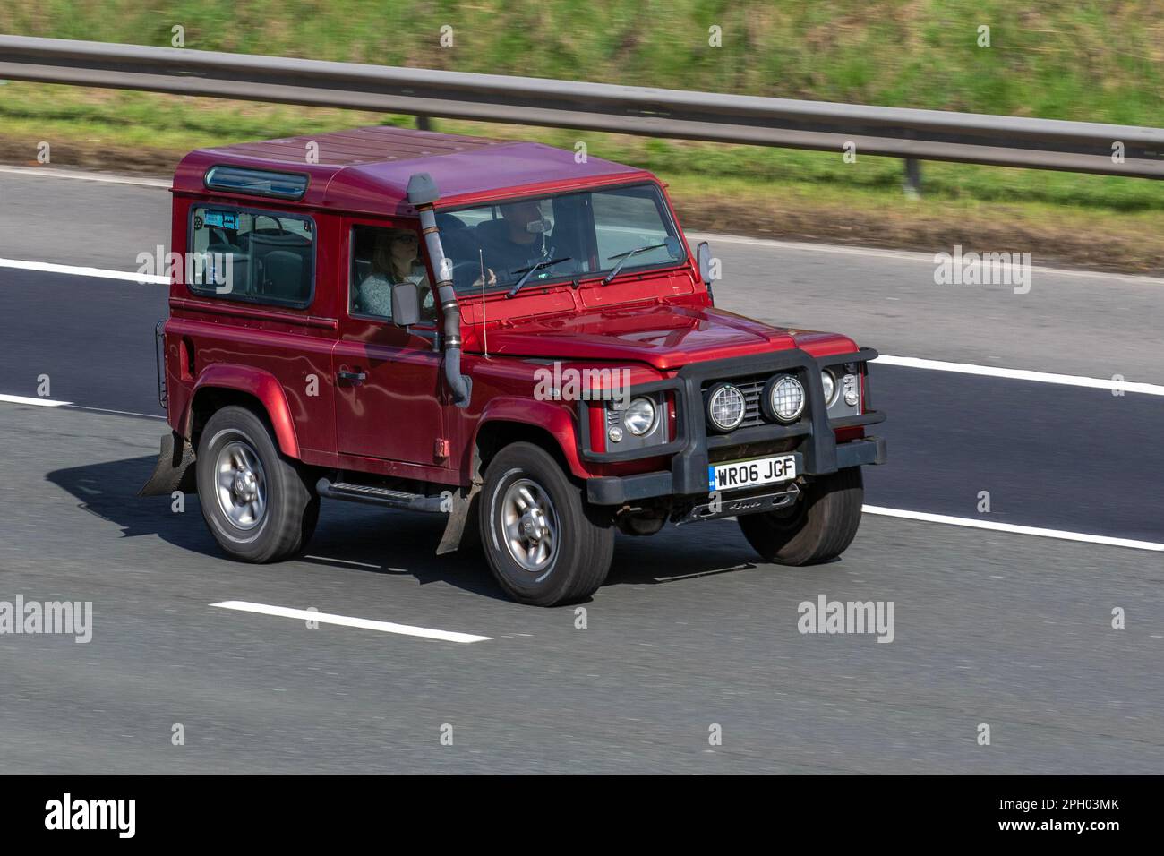 2006 (06) Plate Red SWB LAND ROVER DEFENDER 90 TD5 COUNTY STATION WAGON 2495cc 5 speed manual;  travelling on the M6 Motorway UK Stock Photo