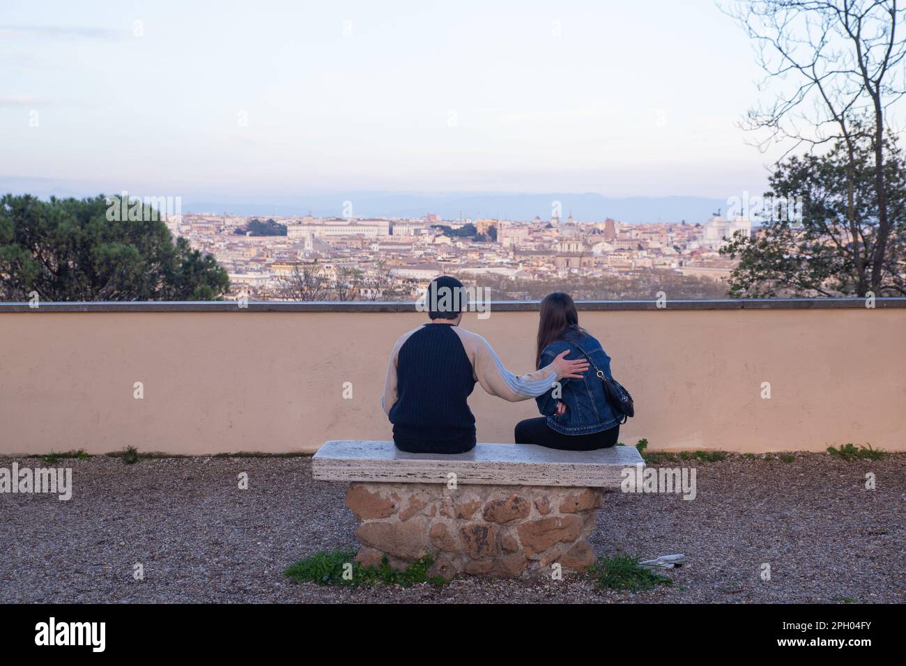 Rome, Italy. 24th Mar, 2023. A boy and a girl are sitting on a bench along the Janiculum Promenade in Rome (Photo by Matteo Nardone/Pacific Press) Credit: Pacific Press Media Production Corp./Alamy Live News Stock Photo