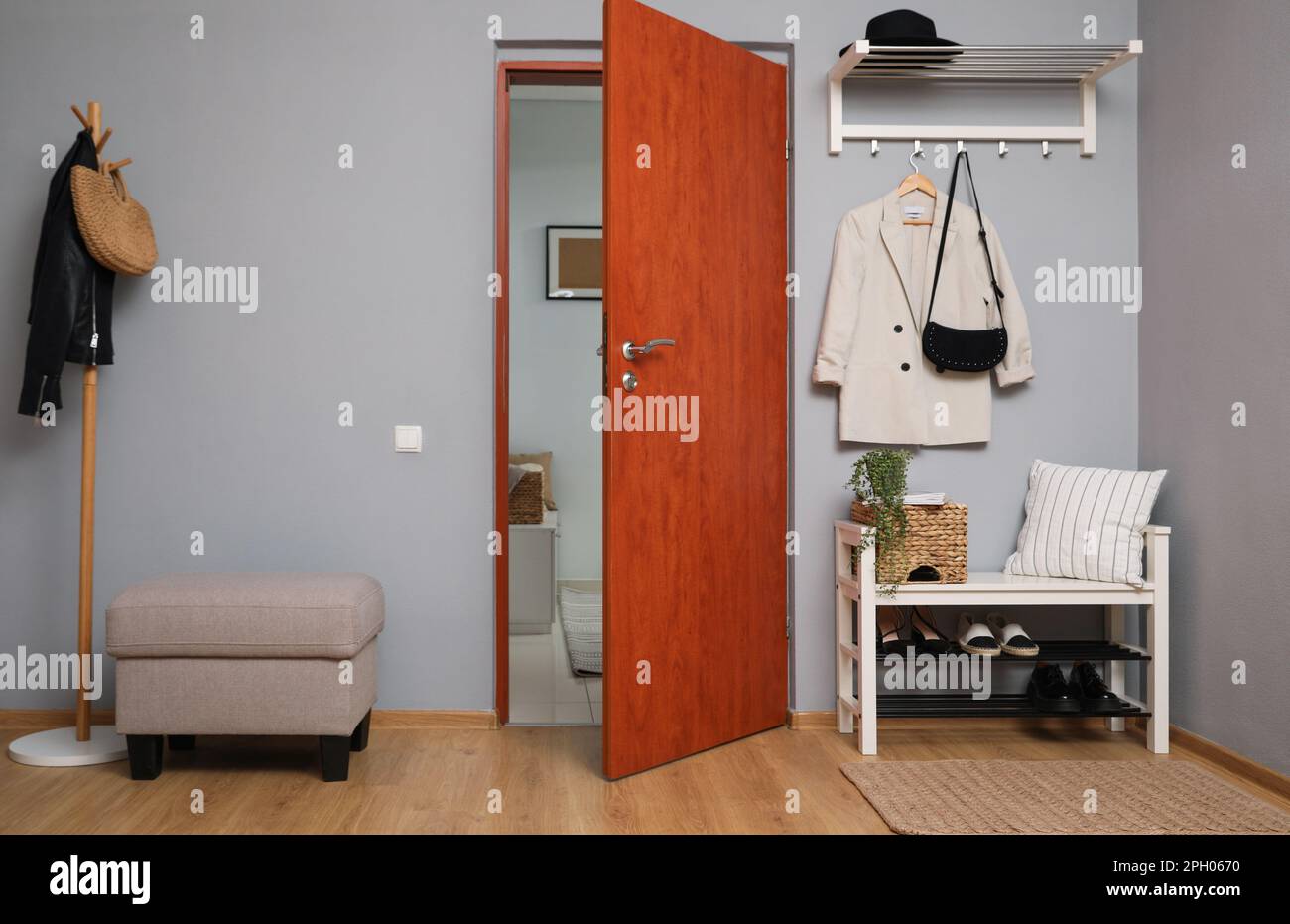 Modern hallway interior with shoe rack and wooden coat stand Stock Photo