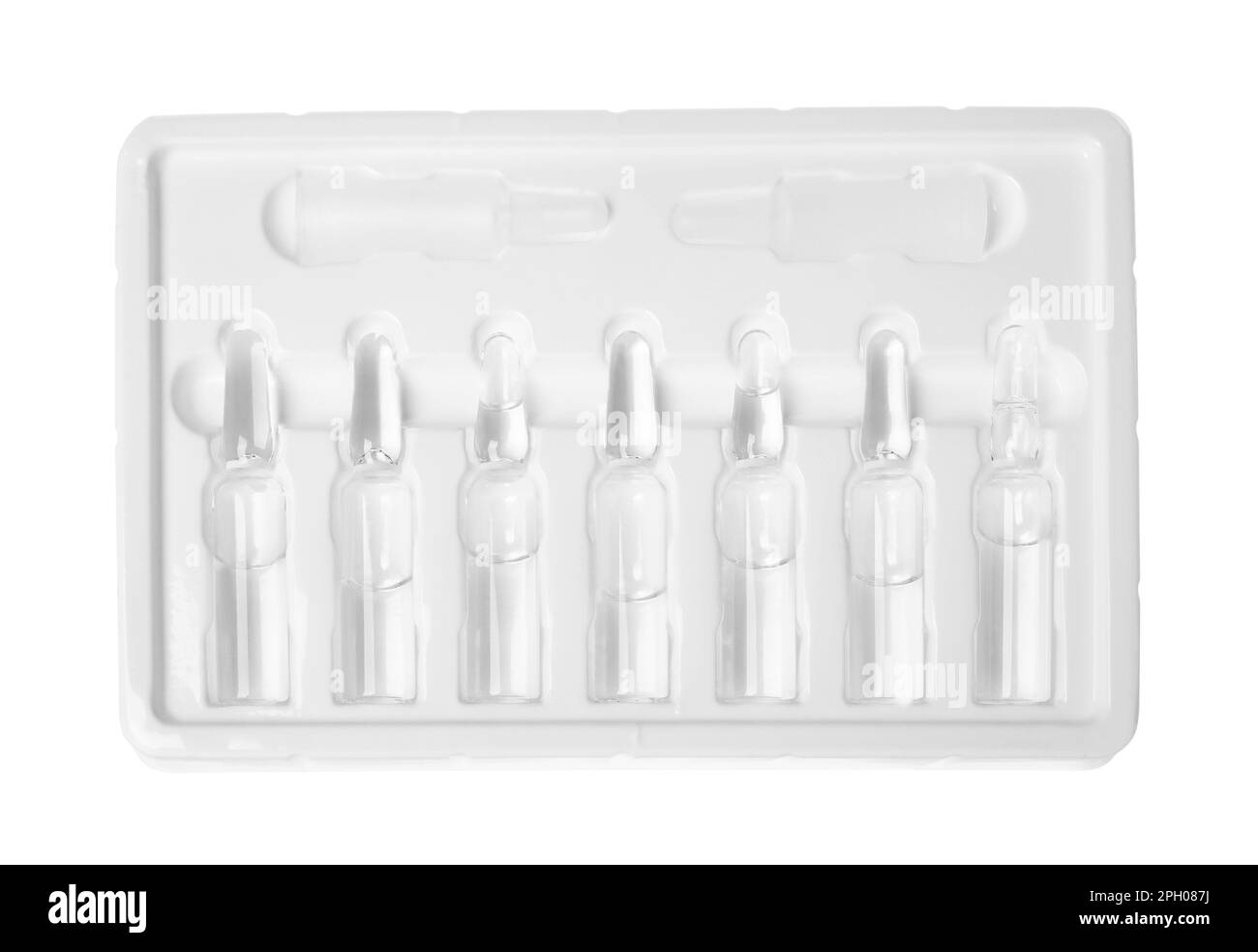 Glass ampoules with pharmaceutical product in tray on white background