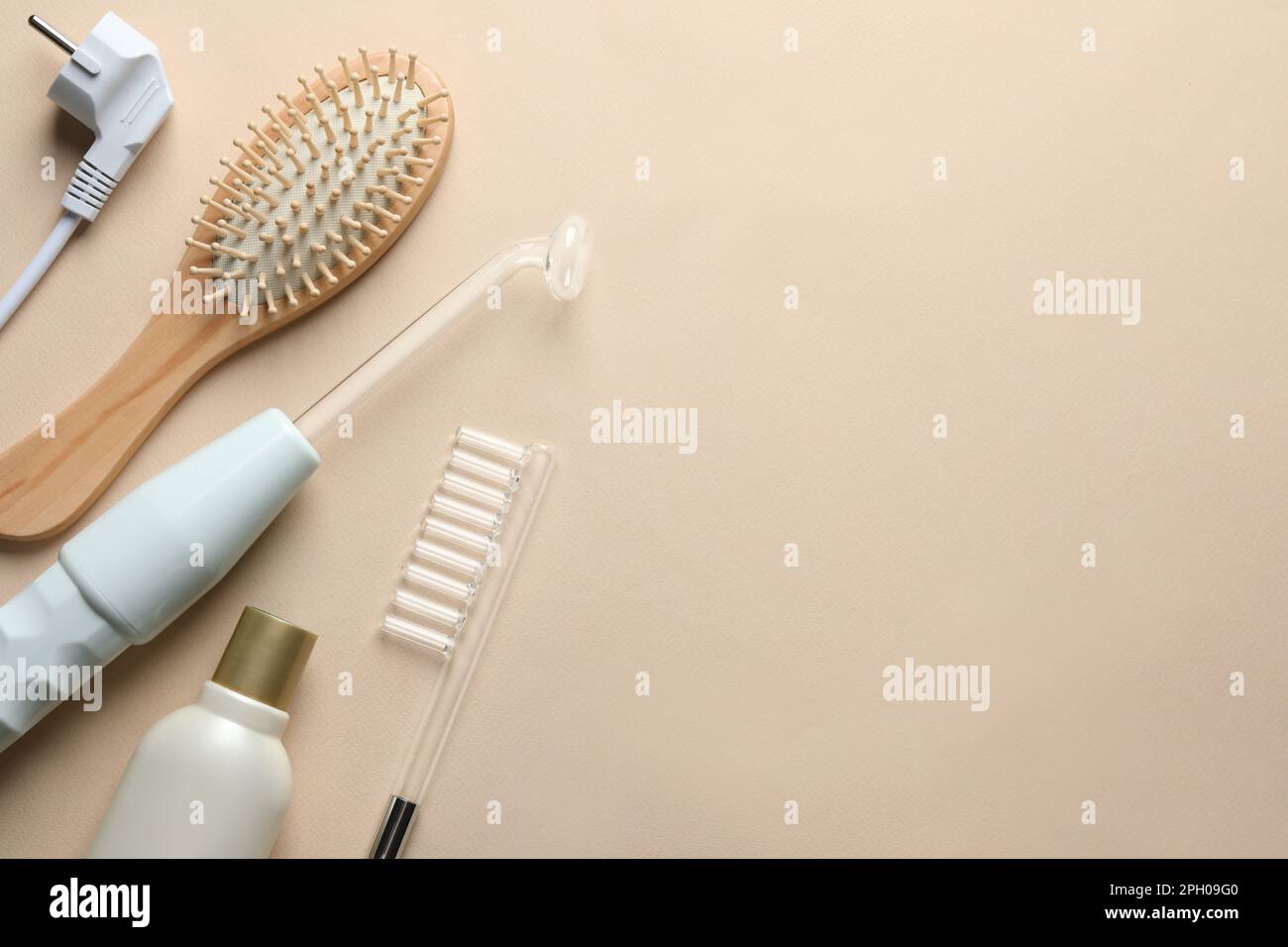 Flat lay composition with darsonval and different nozzles on beige ...