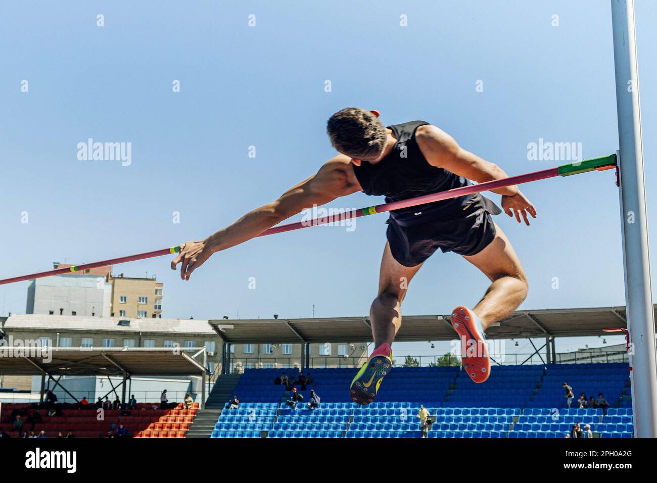 male athlete high jump athletics competition, Nike jump spikes, sports editorial photo Stock Photo
