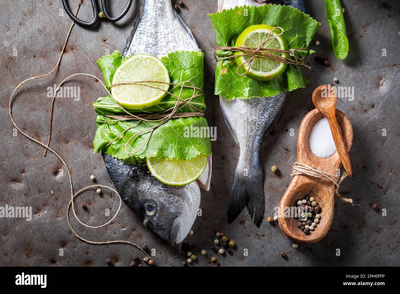 Preparing whole sea bream with horseradish leaves and lime