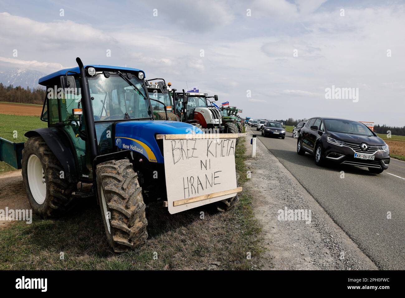 Kranj, Slovenia. 24th Mar, 2023. A tractor with a sign that says 'No farmers, no food' is parked along a busy road during an agricultural reform protest in Kranj. Farmers gathered to protest against the government's planned agricultural reforms in Slovenia. Credit: SOPA Images Limited/Alamy Live News Stock Photo