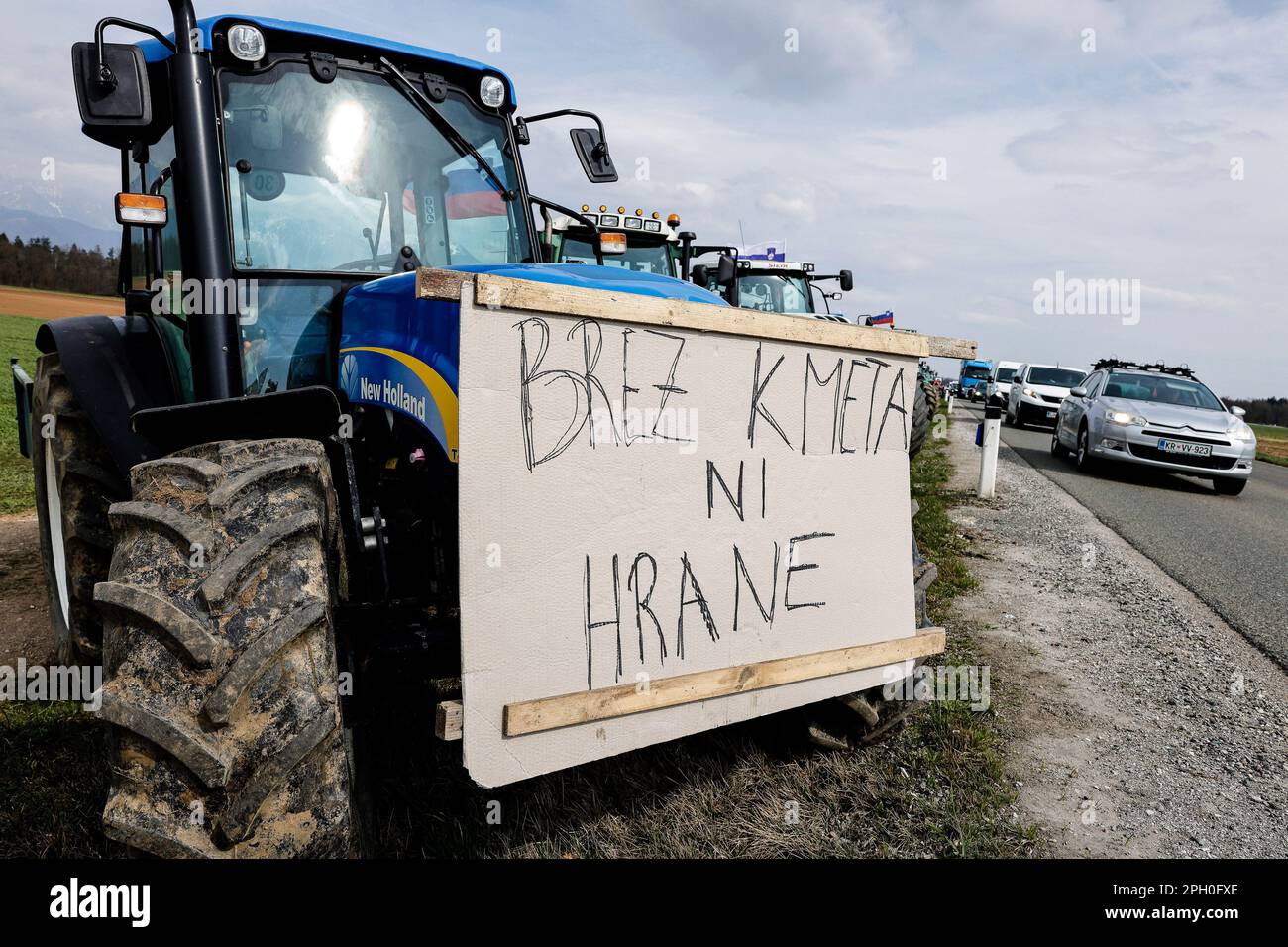 Kranj, Slovenia. 24th Mar, 2023. A tractor with a sign that says 'No farmers, no food' is parked along a busy road during an agricultural reform protest in Kranj. Farmers gathered to protest against the government's planned agricultural reforms in Slovenia. Credit: SOPA Images Limited/Alamy Live News Stock Photo