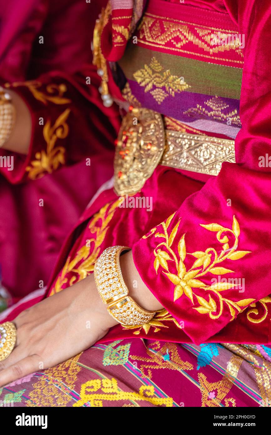 Traditional Balinese female wedding dress and gold jewelry. Bali