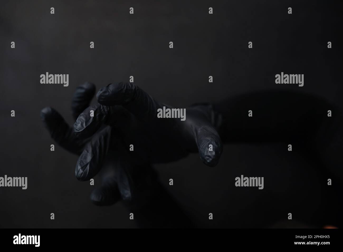 Background of hands in gloves. Black gloves. Hand gestures black gloves