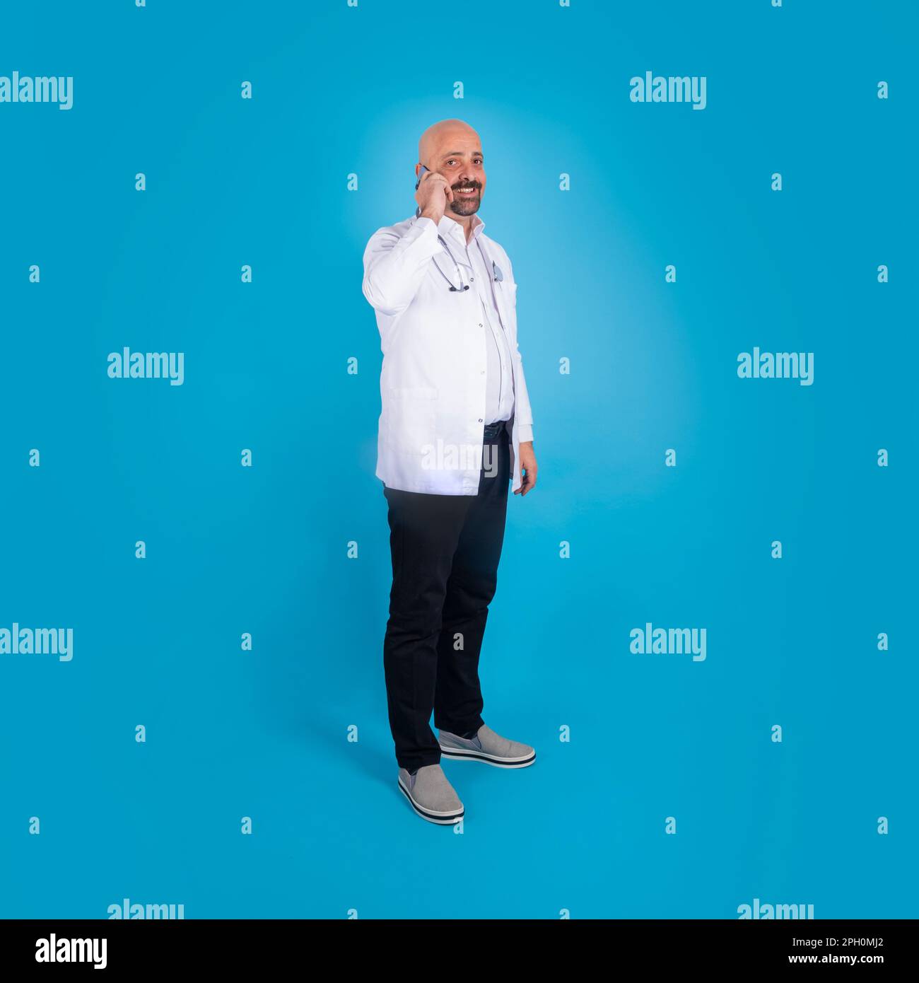 Full body size shot of doctor speaking on the phone. Communication