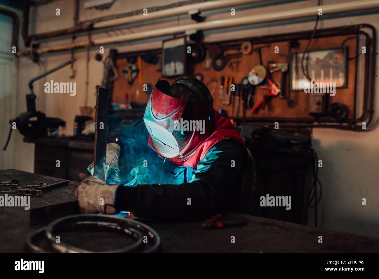 Welder erecting technical steel. Industrial steel welder in factory ...