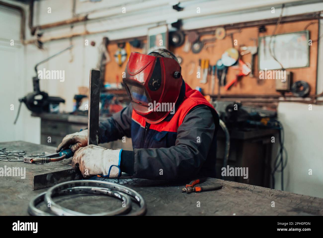 Welder erecting technical steel. Industrial steel welder in factory ...