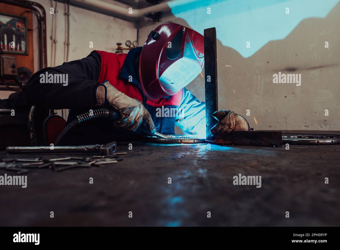 Welder erecting technical steel. Industrial steel welder in factory ...