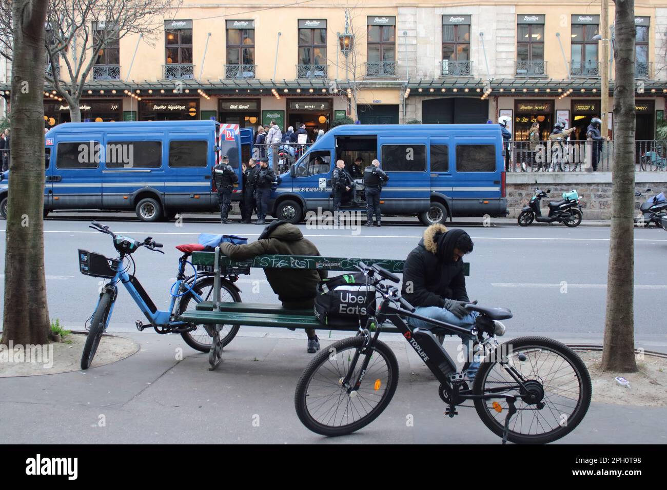 View of french police and cyclists parked up located here along the Boulevard du Temple and Republique district in Paris France. Stock Photo