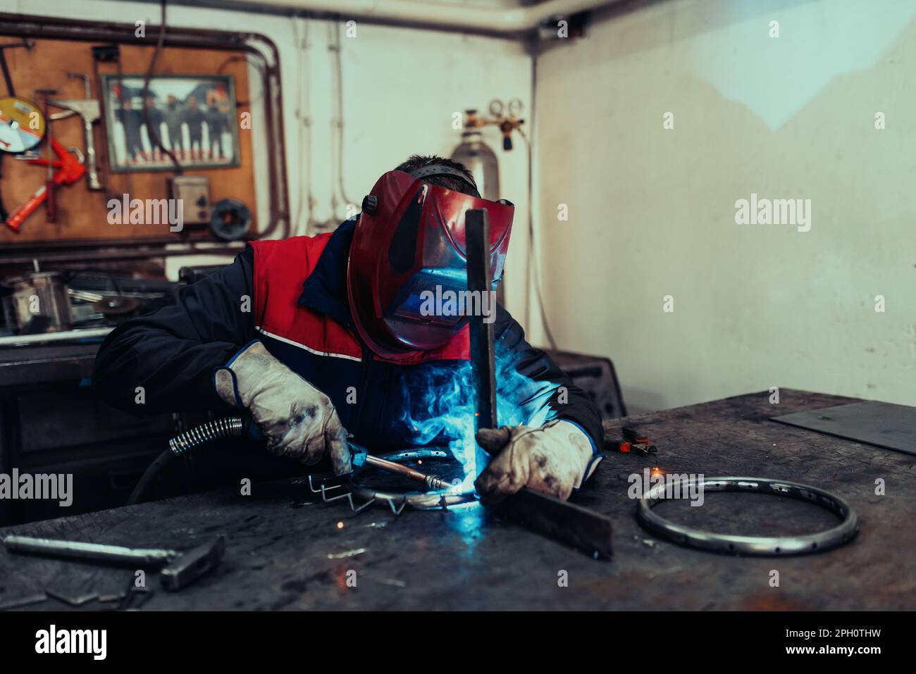 Welder erecting technical steel. Industrial steel welder in factory ...