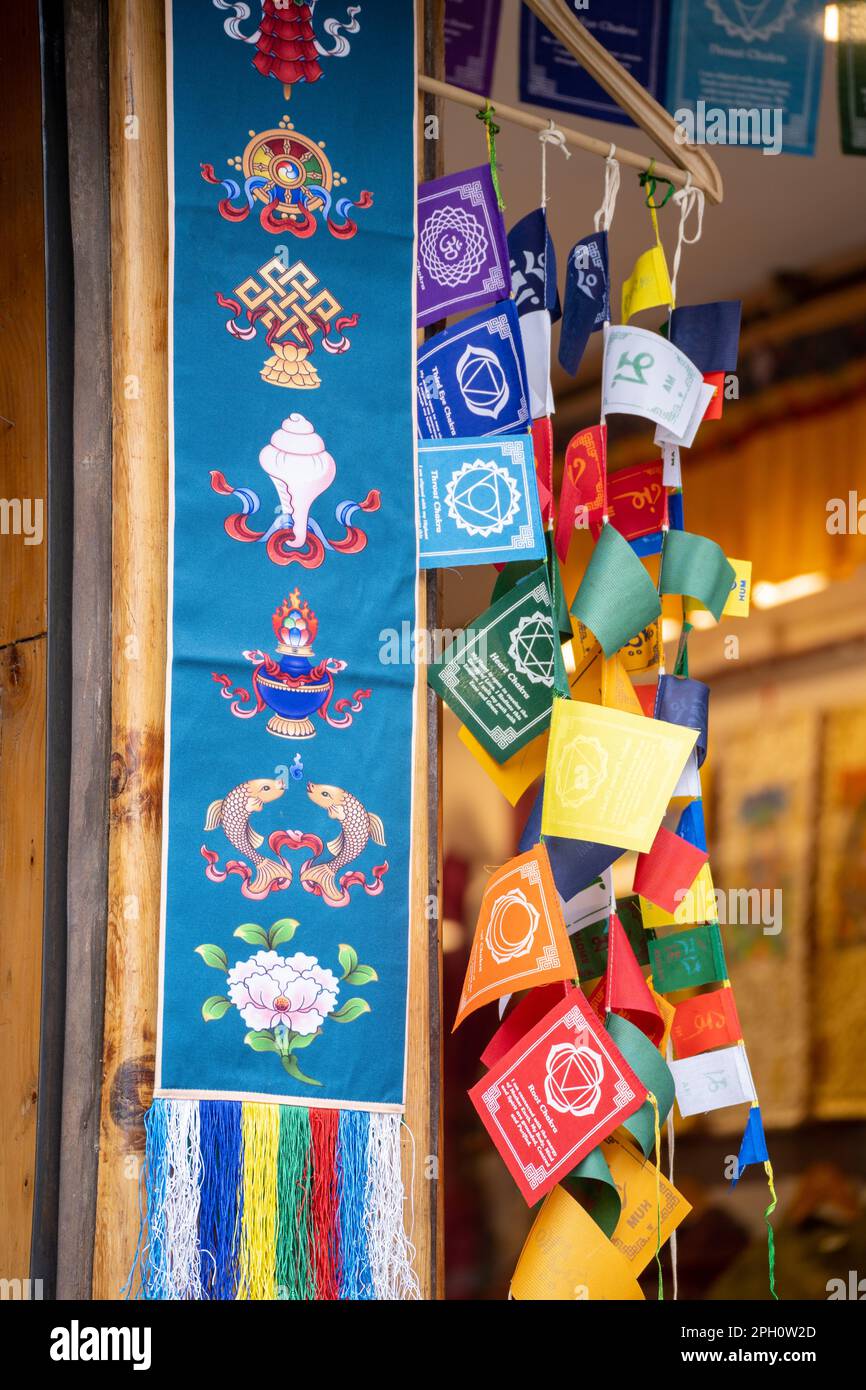 Colorful bhutan bhuddist prayer flags mounted on shop giving common