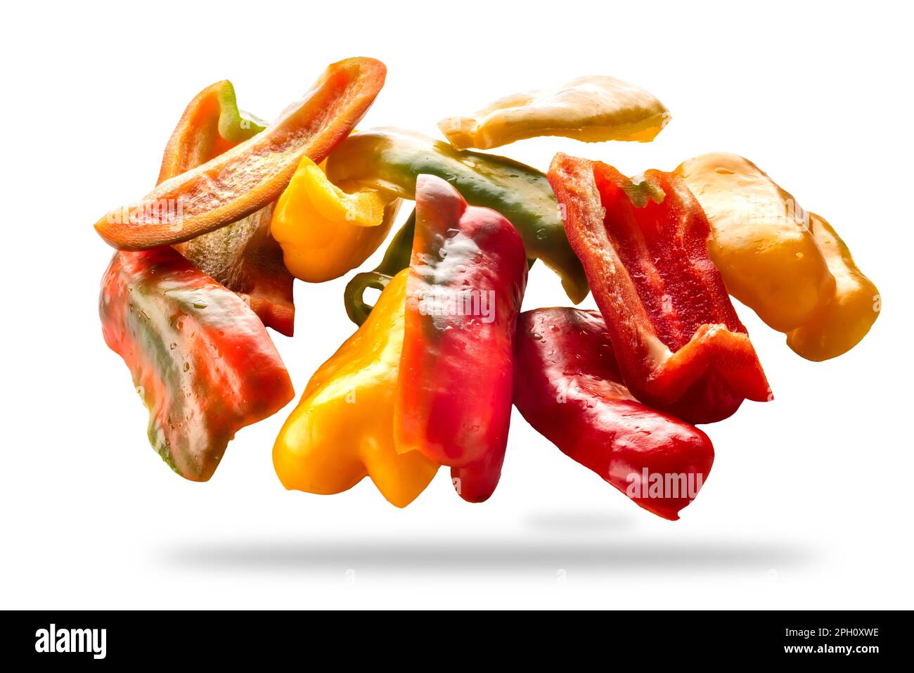 Sliced yellow green and red raw peppers isolated on white with clipping path included Stock Photo