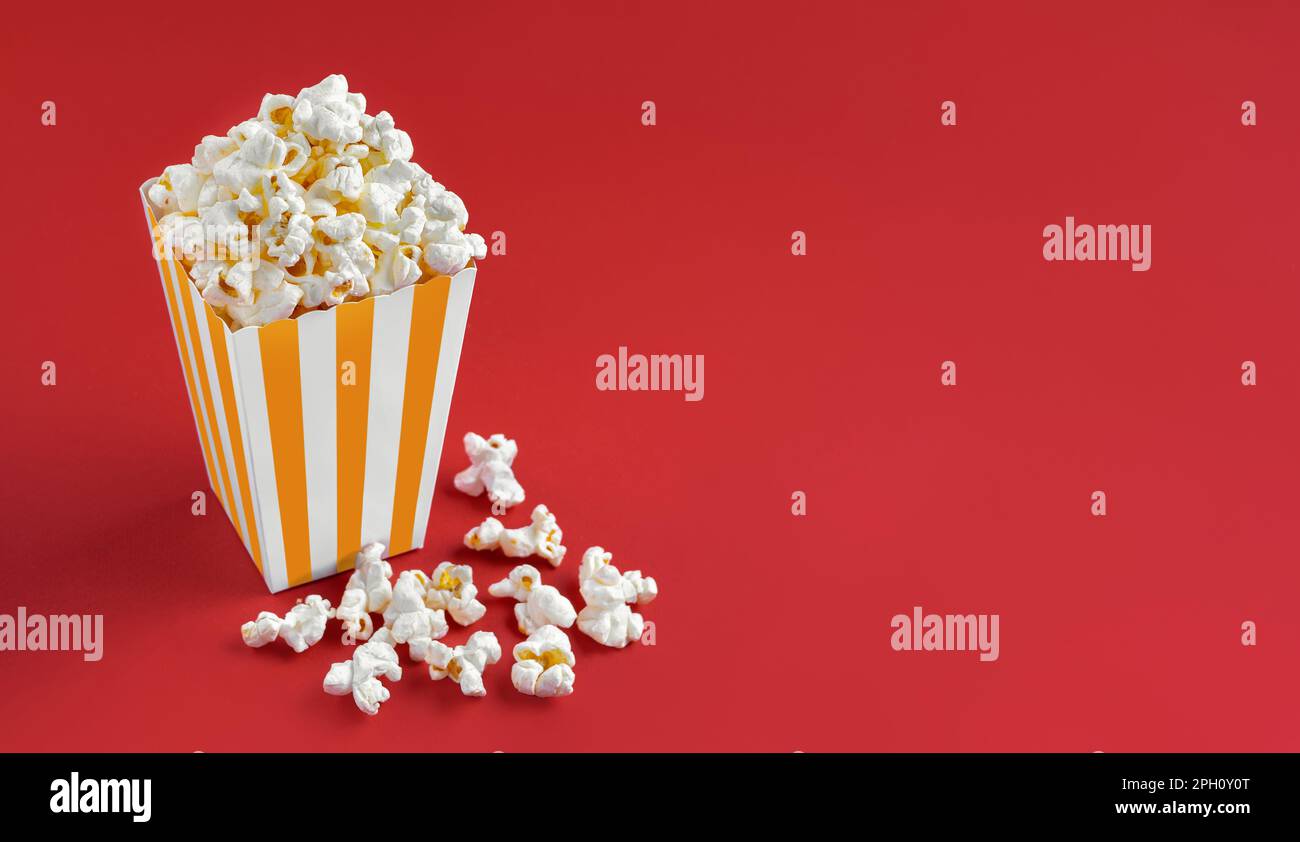 Yellow white striped carton bucket with tasty cheese popcorn, isolated ...