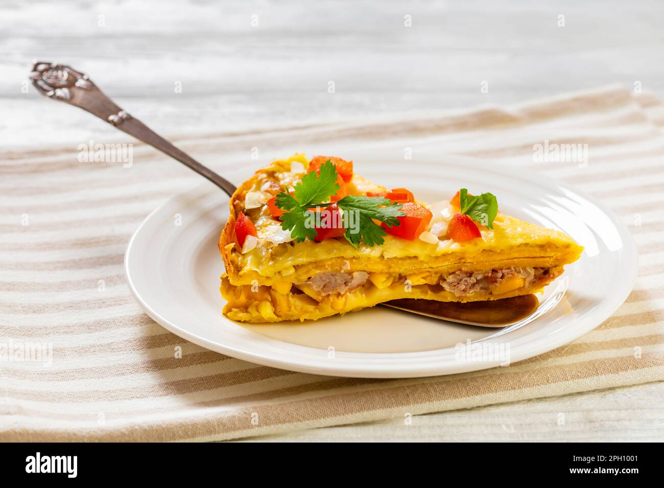 Green Chile Enchilada Casserole of corn tortillas layered with refried
